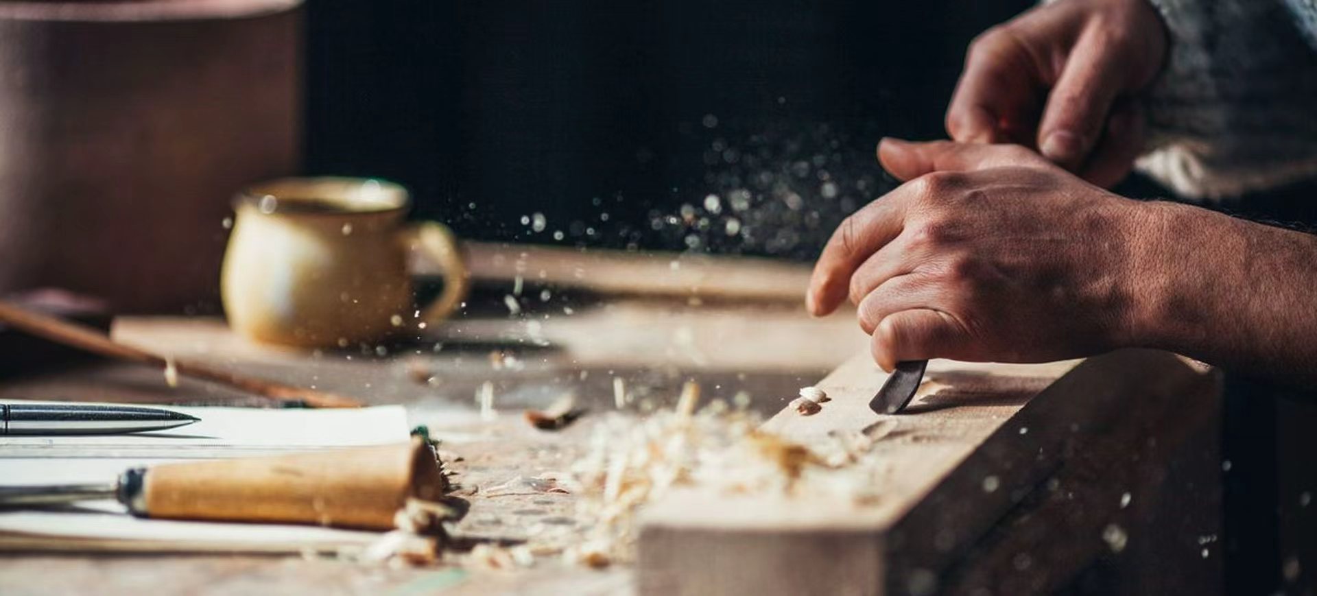 Craftsperson shaping timber by hand